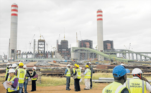 WORK IN PROGRESS: Deputy director-general for nuclear energy in the Department of Energy Zizamele Mbambo (inset) says the government is looking at what role its state-owned enterprise can play in the nuclear build. Right: the Medupi power plant Picture: GALLO IMAGES