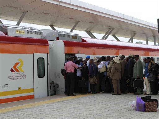 Passengers board a train at the SGR Mombasa terminus