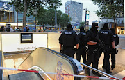 Special police forces stand by the entrance to the subway station of the main train station following shootings at a shopping mall earlier on July 22, 2016 in Munich.