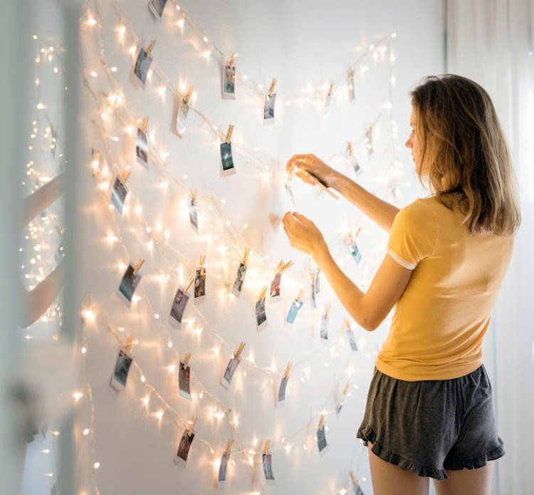 You can peg printed images of family to a string of fairy lights to add a personal feel to your room.