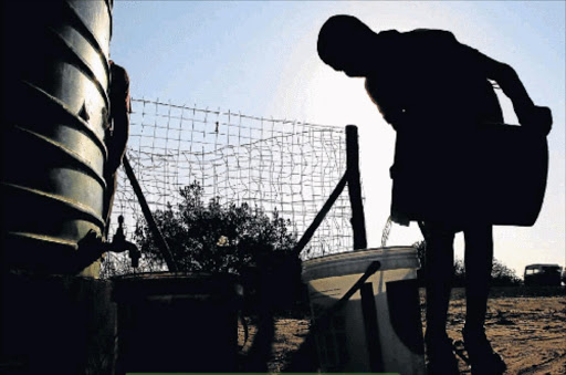 RUNNING DRY: A child collects water from a JoJo tank Picture: FILE