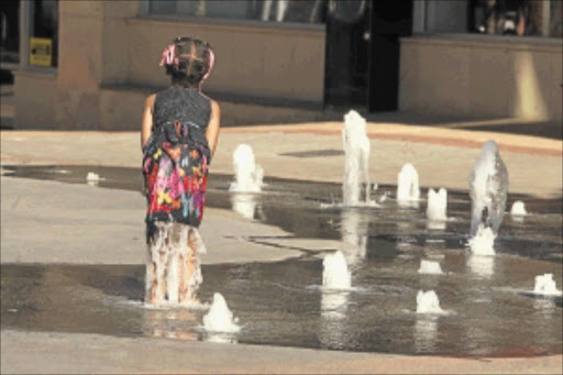 COOLING DOWN: A little girl enjoys the water in the Rosebank Mall. Water scarcity has sparked worries in the country and people have been urged to stop wasting water. PHOTO: MOHAU MOFOKENG