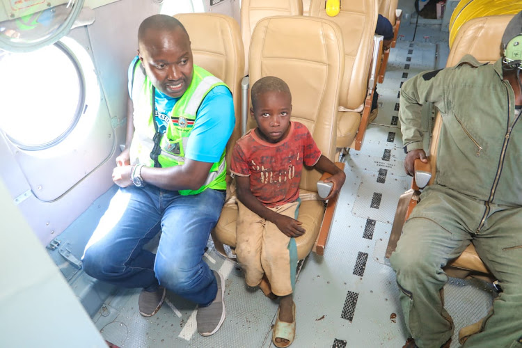 The National Police Service (NPS) Airwing Officers rescue five-year-old Mutuku Kioko after he marooned by floods at Nduani in Yatta, Machakos County on April 23, 2024.