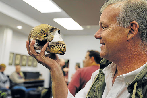 PALEOLITHIC TREASURE: Professor Lee Berger with the ‘Homo naledi’ skull found among a trove of fossils in the Rising Star cave, Cradle of Humankind, North West. Evidence points to the intentional depositing their dead in the remote cave chamber, a behaviour previously thought limited to humans Picture: Moeletsi Mabe/The Times