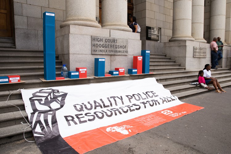 Activists from the Social Justice Coalition demonstrate outside the Equality Court in Cape Town in 2017. Their contention that allocation of police resources in the province discriminates on the basis of race and poverty was upheld by the court.