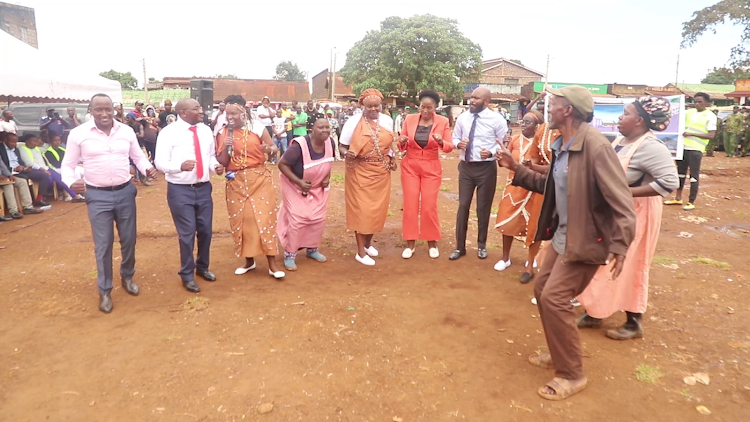 Leaders join traders in a jig during the groundbreaking ceremony of the Gatukuyu market in Gatundu North.