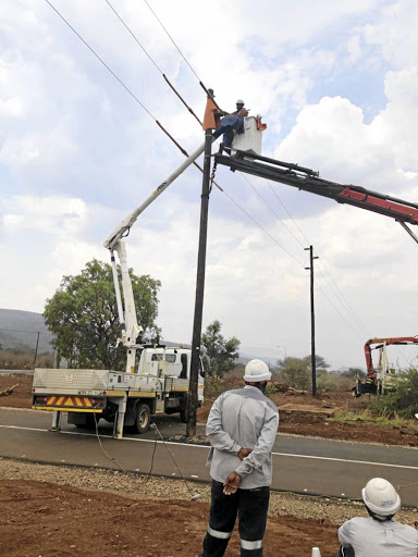 Workers remove a pole from the middle of the road in Limpopo./ SUPPLIED