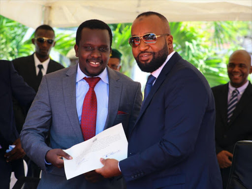 Mombasa governor Hassan Joho with youth and gender executive member Kevin Kyalo during the swearing-in ceremony at Treasury square, November 16, 2017. /John Chesoli