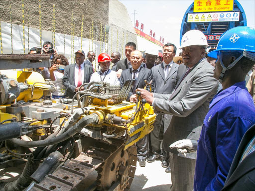 President Uhuru Kenyatta operates a machinery to officially launch construction works of the Phase 2A of the Standard Gauge Railway (SGR) project at Em-bulbul, Kajiado County on October 27,2016.Photo PSCU