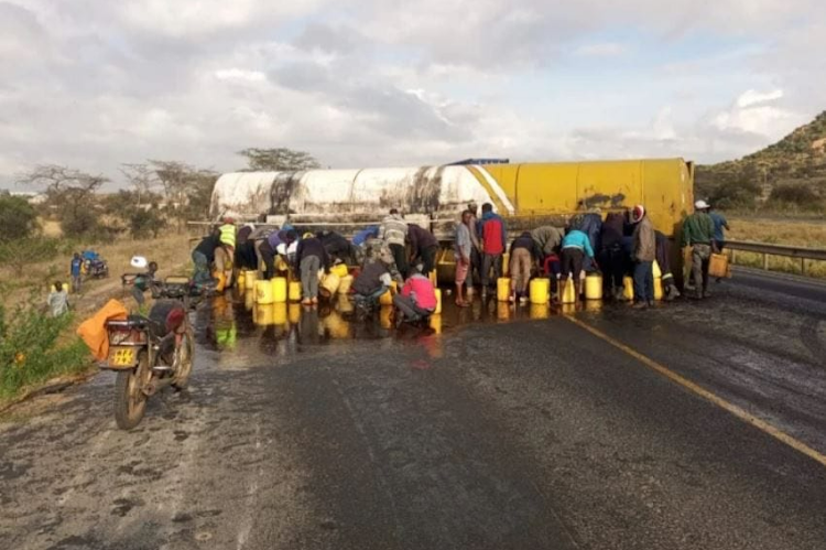 Residents scramble for palm oil from a tanker that overturned along Nairobi - Mombasa highway at Lukenya area in Athi River, Machakos County on March 27, 2024.