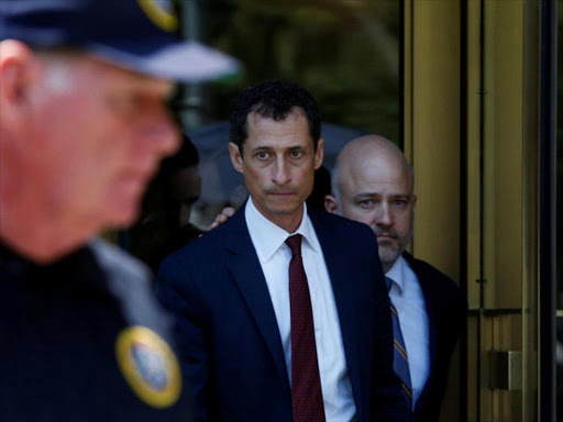 Former U.S. Congressman Anthony Weiner exits US Federal Court with attorney Arlo Devlin-Brown (back, R), after pleading guilty to one count of sending obscene messages to a minor, ending an investigation into a "sexting" scandal that played a role in last year's US presidential election, in New York City, US, May 19, 2017. /REUTERS