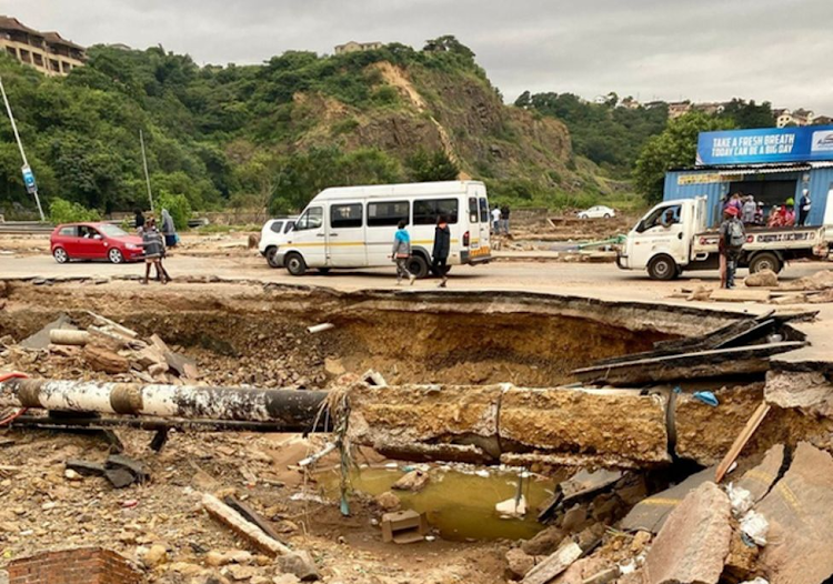 A photo showing a washed off section of the road in South Africa following deadly floods that killed over 300 people.