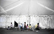 TOUGH LIFE: Children of  refugees play in a  camp in Chatsworth,  Durban. Some of the children were born in South Africa and, according to Home Affairs, that does  not guarantee them  automatic citizenship  Photo: TEBOGO LETSIE