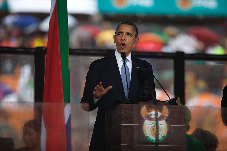 Former President of The United States of America, Barack Obama addresses the crowd at Nelson Mandela memorial service at the FNB Stadium in Soweto, Johannesburg..
