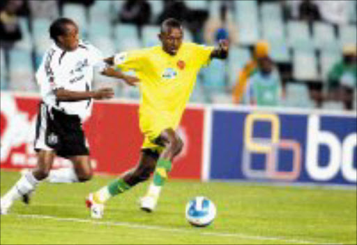 SWIFT MOVER: Katleho Loke of Benoni United watzes past Pirates Bennet Chenene to lead his team in their Telkom knockout Cup match at Ellis Park Stadium last night. Pic. Antonio Muchave. 03/10/07. © Sowetan.