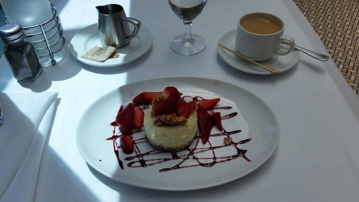 Awesome Chevre cheesecake with port-marinated strawberries and a buttery walnut crust, garnished with strawberry sauce and candied walnuts! So good! Don't let the size fool you. It is very rich.