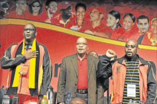 COMRADES IN SONG: Cosatu general-secretary Zwelinzima Vavi, President Jacob Zuma and Cosatu president Sdumo Dlamini sing the national anthem at the start of Cosatu's national congress. photo: GCIS
