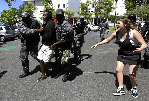 A University of Cape Town student is upset by campus security arresting a fellow demonstrator during a #FeesMustFall protest. The university has established a commission that is aimed at addressing the financial, political and other issues underlying the student anger.