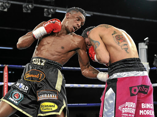 Thulani Mbenge, left, digs a left uppercut on Diego Chaves.