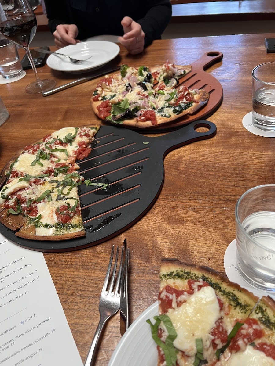 GF margherita pizza in front; GF veggie pizza in back