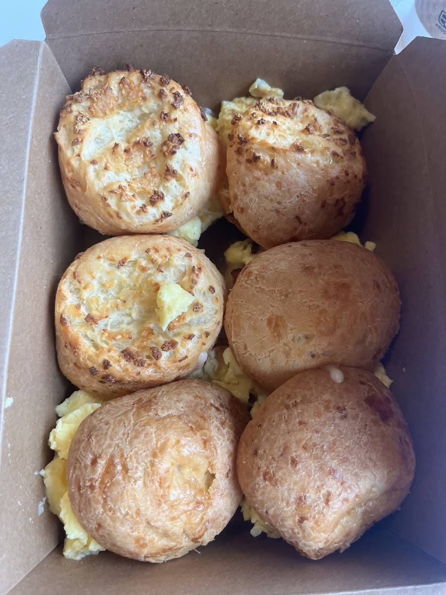 Garlic pão de queijo with bacon, egg, and cheese (top left) and traditional (bottom right)