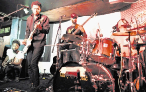 Fans listen to the sounds of the BLK JKS performing at Buccaneers Pub and Grill yesterday evening. The Johannesburg group has signed with a US record label. Pic : ALAN EASON. 18/02/2009. © Daily Dispatch.