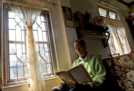 Amihud Phaltual, a senior member of the local 'Bnei Menashe' community and chairman of Beith Shalom Synagogue sits in his home reading from a Hebrew manuscript, in Churachandpur district of north eastern state of Manipur. File photo.