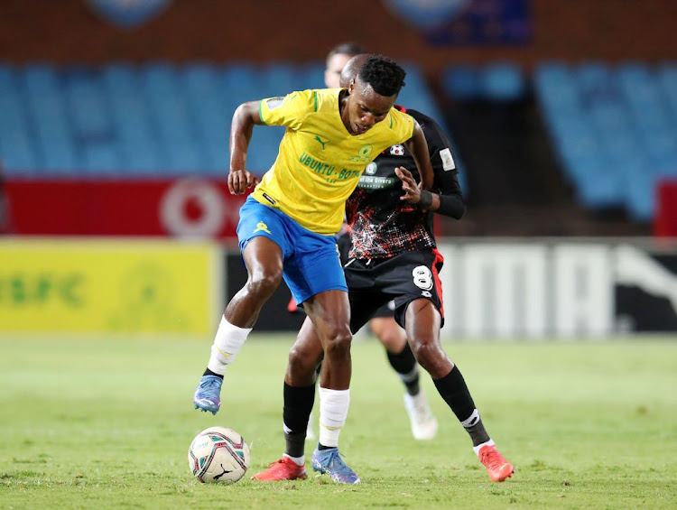 Themba Zwane of Mamelodi Sundowns is challenged by Zukile Kewuti of Maritzburg United during the DStv Premiership match between the two sides at Loftus Versfeld Stadium on November 3 2021 in Pretoria.