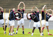 The Springboks stretch before a training session at Western Springs Stadium in Auckland. The team plans to dominate by kicking for field position and putting pressure on their opponents through their defence