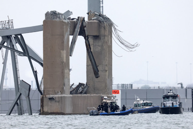 Emergency boats work near the collapsed section of the Francis Scott Key Bridge, after the Dali cargo vessel crashed into it, in Baltimore, Maryland, the US, March 27 2024. Picture: REUTERS/Mike Segar