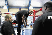 FAMILIAR TERRITORY: Floyd Mayweather climbs through the ropes at Dube Boxing club in Soweto, where a plaque was unveiled for late four-time world champion Baby Jake Matlala. The Matlala family was present. Picture: ALON SKUY