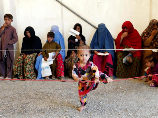 Afghan women sit with their children after arriving at a United Nations High Commissioner for Refugees (UNHCR) registration centre in Kabul, Afghanistan September 27, 2016. /REUTERS