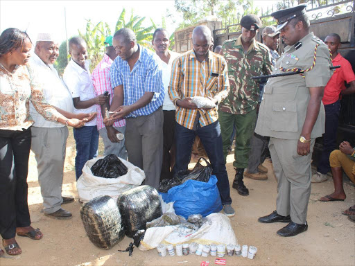 Police with the Sh300,000 bhang found in a house in Maragua town on Wednesday/ ALICE WAITHERA