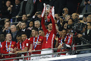 Man of the match, Manchester United's Swedish striker Zlatan Ibrahimovic lifts the trophy as Manchester United players celebrate their victory after the English League Cup final football match between Manchester United and Southampton at Wembley stadium in north London on February 26, 2017. Zlatan Ibrahimovic sealed the first major silverware of Jose Mourinho's Manchester United reign and broke Southampton's hearts as the Swedish star's late goal clinched a dramatic 3-2 victory in Sunday's League Cup final.
