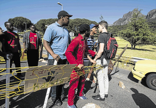 BACKLASH: A UCT student tries to get through a barricade to the campus, erected in protest against fee increases and the slow pace of transformation of the university. File photo