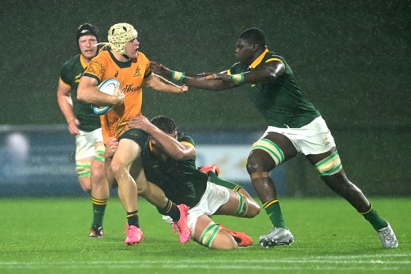 Angus Staniforth of Australia is tackled while Bathobele Hlekani gives chase during the Under-20 Rugby Championship match against South Africa at Sunshine Coast Stadium on Tuesday.