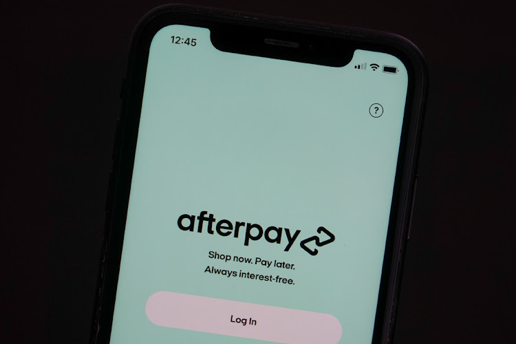 The Afterpay app is seen on the screen of a mobile phone in a picture illustration taken August 2 2021. Picture: REUTERS/LOREN ELLIOTT