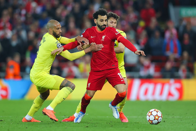 Mohamed Salah of Liverpool battles for possession with Etienne Capoue and Alfonso Pedraza of Villarreal in the Uefa Champions League semifinal first leg at Anfield in Liverpool on April 27 2022.