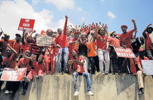 PAYBACK TIME: Economic Freedom Fighters (EFF) supporters are seen singing anti President Jacob Zuma songs after arriving at the Constitutional Court during the EFF march to the Constitution Hill in Johannesburg yesterday. The opposition party marched to the Constitutional Court after going to court to force Zuma to pay back public money allegedly spent on his Nkandla homestead Picture: EPA