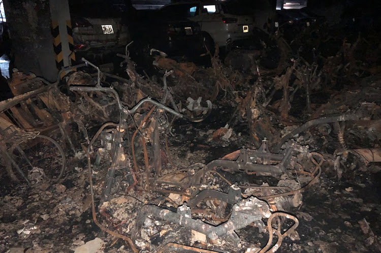 Motorbikes are seen burned down in a parking lot after a fire broke out in an apartment block in Ho Chi Minh City.