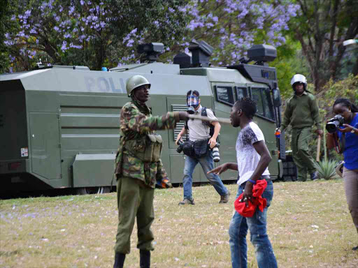 A protester is rounded by anti-riot police officers during an anti-corruption demonstration at Freedom Corner in Uhuru Park, Nairobi, in the wake of the Sh5.3 billion Health ministry scandal, November 3, 2016. /PATRICK VIDIJA