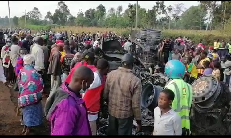 Locals at the scene where a fuel tanker exploded in Malanga Village Gem sub county, Siaya county on Saturday night.