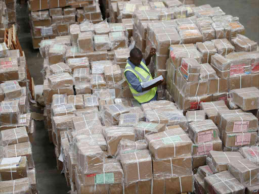 Verification officer Titus Ojore of Tusome Project inspects part of 5.4 million copies of English and Swahili books at Balore Logistics Warehouse in Embakasi on April 14, 2016. /JACK OWUOR