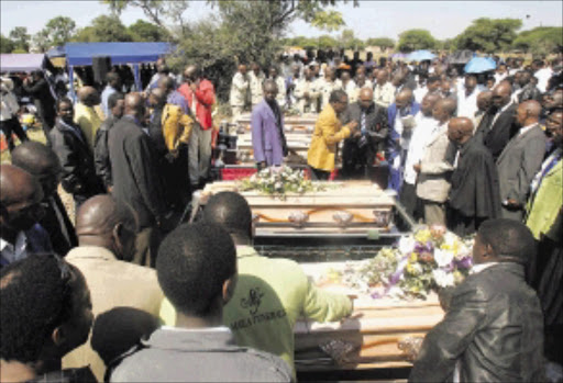 MASS BURIAL: Mourners at the graveside during the burial of five children killed when a goods train collided with a taxi on a level crossing at Sandfontein village, outside Rustenburg in North West. Pic: VELI NHLAPO. 14/03/2010. © Sowetan.