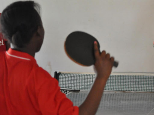 A table tennis player in action.
