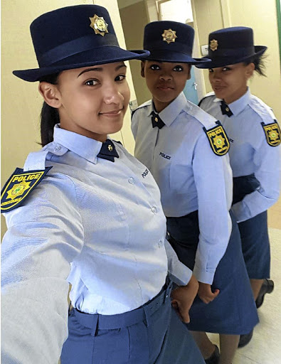 Policewomen posing in uniform.