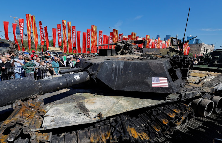 Visitors stand behind barriers while looking at a destroyed US-manufactured Abrams main battle tank at an exhibition displaying armoured vehicles and equipment captured by the Russian army from Ukrainian forces in the course of Russia-Ukraine conflict, at Victory Park open-air museum on Poklonnaya Gora in Moscow, Russia, on May 1 2024.