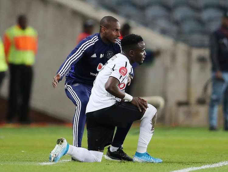 Orlando Pirates interim coach Rulani Mokwena gives instruction to forward Gabadinho Mhango during a match.