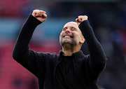 Manchester City manager Pep Guardiola celebrates after their FA Cup semifinal win against Chelsea at Wembley Stadium in London on Saturday.