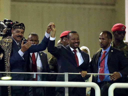 Eritrea's President Isaias Afwerki and Ethiopian Prime Minister Abiy Ahmed hold hands during a concert at the Millennium Hall in Addis Ababa, Ethiopia July 15, 2018. /REUTERS